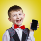 Small boy laughing after reading funny text message